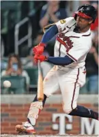  ?? AP PHOTO/JOHN BAZEMORE ?? The Atlanta Braves’ Ozzie Albies drives in the winning run with a sacrifice fly against the Los Angeles Dodgers during the ninth inning Wednesday night in Atlanta.