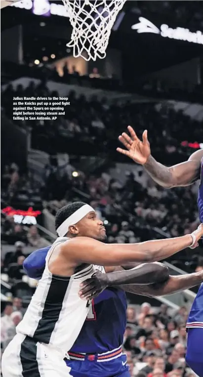  ??  ?? Julius Randle drives to the hoop as the Knicks put up a good fight against the Spurs on opening night before losing steam and falling in San Antonio. AP