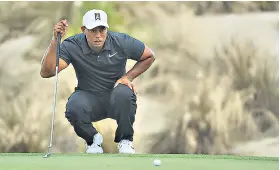  ??  ?? Crouching Tiger: Fit-again Woods lines up a putt at the Bahamas yesterday