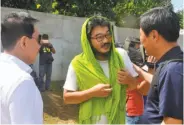  ?? Nickee Butlangan / AFP / Getty Images ?? Released hostage Park Chul-hong (center) visits with local officials Saturday in Jolo, Philippine­s.