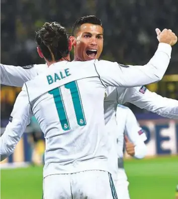  ?? AP ?? Real Madrid’s Cristiano Ronaldo and Gareth Bale celebrate their side’s second goal during the Champions League Group H match against Borussia Dortmund in Dortmund on Tuesday.