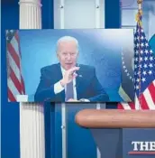  ?? DREW ANGERER/GETTY ?? President Joe Biden is displayed on a monitor in the press briefing room Tuesday at the White House while he attends a virtual meeting with governors.