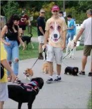  ?? NEWS-HERALD FILE ?? Jacob Strong of Mentor, center, stands out in a sea of other dog lovers in his Welsh corgi T-Shirt while he and girlfriend Alexis Jaskela, left, walk Strong’s Welsh corgi, Wilson, through the crowd at Woofstock in this file photo.