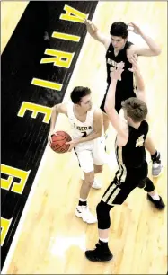  ?? MARK HUMPHREY ENTERPRISE-LEADER ?? Prairie Grove senior Riley Rhodes tries to work out of a half-court trap employed by Pottsville. Rhodes scored 11 points, but the Tigers lost to the Apaches, 51-35, at home on Nov. 27.