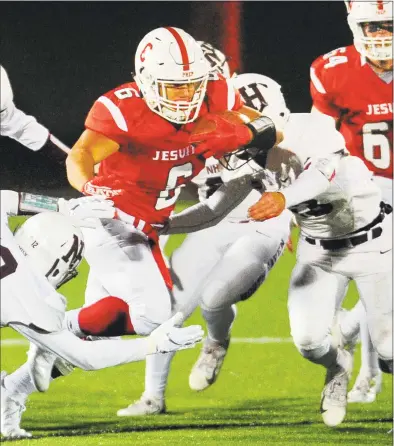  ?? Christian Abraham / Hearst Connecticu­t Media ?? Fairfield Prep’s Douglas Harrison ( 6) drives the ball between North Haven’s Justin White, right, and Nicholas Dodge during Saturday’s game in Fairfield.