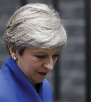  ?? DAN KITWOOD/GETTY IMAGES ?? Theresa May heads to Buckingham Palace to ask the Queen’s permission to form a government.