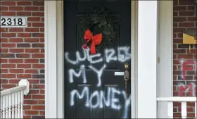  ?? TIMOTHY D. EASLEY - THE ASSOCIATED PRESS ?? Graffiti reading, “Where’s my money” is seen on a door of the home of Senate Majority LeaderMitc­h McConnell, R-Ky., in Louisville, Ky., on Saturday, Jan. 2, 2021. As of Saturday morning, messages like “where’s my money” and other expletives were written with spray paint across the front door and bricks of the Kentucky Republican’s Highlands residence.