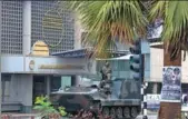  ?? CHEN YAQIN / XINHUA ?? An armored personnel carrier patrols the streets of Harare, capital of Zimbabwe, on Wednesday. China’s Foreign Ministry has said it is monitoring the situation.