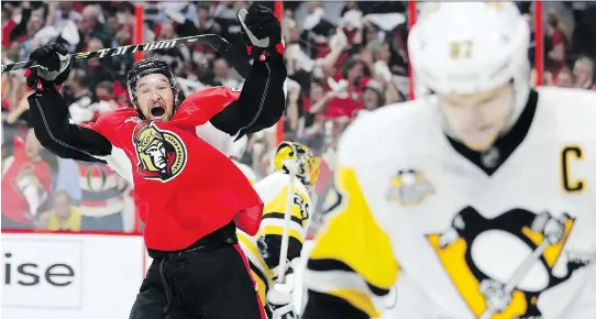  ?? WAYNE CUDDINGTON ?? Ottawa Senators right wing Mark Stone celebrates the Senators’ fourth goal of the first period as Pittsburgh Penguins captain Sidney Crosby, right, skates away during Game 3 of the Eastern Conference final on Wednesday in Ottawa. Crosby got...