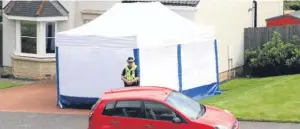  ??  ?? Top: William Handy, left, and Craig Guest. Above: A police tent concealing the car in the aftermath of the crime.