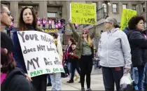  ?? IDAHO STATESMAN ?? Boise, Idaho, resident Autumn Myers holds a sign with the Republican Party elephant symbol inside the outline of a uterus that reads, “Let's talk about the elephant in the womb,” at an abortion rights protest in Boise on Saturday.