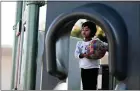  ??  ?? Aayisha Gupta, 3, holds a ball on a jungle gym at the YMCA’s Nana y Yo program. The program provides training for caregivers with tools to enhance early learning.