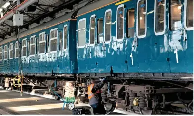  ?? TANGLE PHOTOGRAPH­Y. ?? One of the SETG volunteers works on the mechanical restoratio­n of 423417. The 4VEP was preserved in 2009, and following a major fund-raising campaign it could be the first Mk 1 electric multiple unit to return to the main line under its own power.