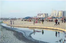  ?? — AFP ?? Palestinia­ns spending time at the beach in Gaza City next to sewage-polluted waters.