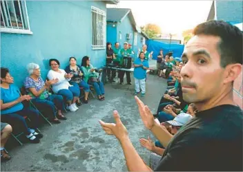  ?? Luis Sinco Los Angeles Times ?? RESIDENTS AND ACTIVISTS gather in the backyard of a home east of downtown Los Angeles to celebrate the closure in March 2015 of the Exide Technologi­es battery recycling plant in Vernon.