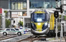  ?? LANNIS WATERS / THE PALM BEACH POST ?? Brightline’s passenger trains are expected to reach speeds of up to 79 mph between Miami and West Palm Beach. A plan to create quiet zones to silence train horns at crossings is on track after service launches, officials said.