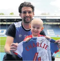  ??  ?? Charlie Procter, with Blackburn Rovers player, Charlie Mulgrew and his signed shirt