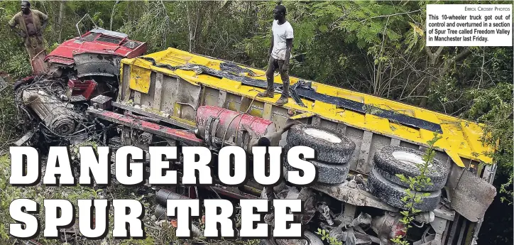  ?? ERROL CROSBY PHOTOS ?? This 10-wheeler truck got out of control and overturned in a section of Spur Tree called Freedom Valley in Manchester last Friday.