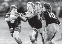  ?? GRAEME BROWN/STUFF ?? Australia wing Willie Carne, left, tries to get away from Kiwis Jarrod Mccracken and Brent Todd in the pouring rain.