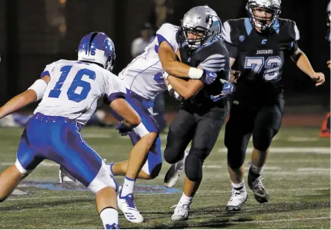  ?? PHOTOS BY LUIS SÁNCHEZ SATURNO/THE NEW MEXICAN ?? Capital’s Luke Padilla is tackled during the second quarter of a Sept. 14 game against St. Michael’s. The Horsemen routed the Jaguars 42-6. The Jaguars hope to turn things around Friday against Moriarty.