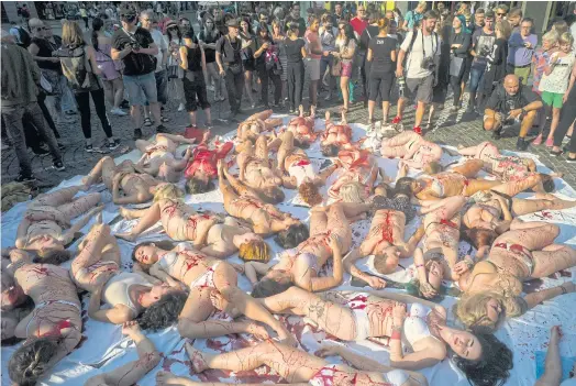  ??  ?? BLOODY BUSINESS: Animal rights activists stage a protest in Prague last month against animal abuse.