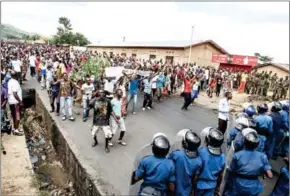  ?? JENNIFER HUXTA/AFP ?? Burundi riot police and armed forces are confronted by stone-throwing protesters during a demonstrat­ion against incumbent president Pierre Nkurunziza’s bid for a third term in May 2015, in Bujumbura.