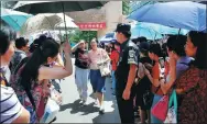  ?? WANG JING / CHINA DAILY. ?? completed the exam at the Affiliated School of Peking University in Beijing. Parents welcome children who have