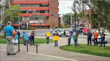  ?? Herald photo by Tim Kalinowski ?? Protesters gather on the steps of city hall Monday afternoon to demand officials respond to the unsanction­ed supervised consumptio­n site set up in two city parks over the weekend.