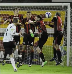  ??  ?? September 2012 - the Bohemians wall of (l to r) Evan McMillan Roberto Lopes, Derek Pender and Ryan McEvoy fail to stop Marc Griffin’s free kick finding the net for Dundalk’s winner in the FAI Ford Cup quarter-final at Dalymount Park.