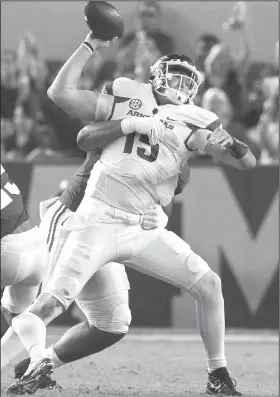  ?? Arkansas Democrat-Gazette/BENJAMIN KRAIN ?? Arkansas quarterbac­k Cole Kelley tries to get rid of the football Saturday before being sacked by Alabama's DaRon Payne in Alabama.
