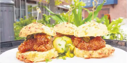  ?? SCOTT ADAMS CREATIVE ?? Thigh High Chicken Biscuits, Chef Art Smith’s Homecomin’ Florida Kitchen: Three cheddar drop biscuit sandwiches with Chef Art Smith’s famous fried chicken thighs drizzled in hot orange blossom honey and served with house-made bread and butter pickles.