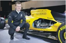  ??  ?? Félix Lamy of Gatineau, Ont., winner of the 2016 Canadian Infiniti Engineerin­g Academy placement opportunit­y, poses beside a Renault Sport Formula One race car at the 2017 Montreal Internatio­nal Auto Show Jan. 19, 2017.