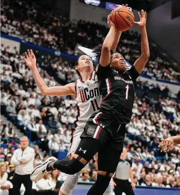  ?? Jessica Hill/Associated Press ?? UConn’s Lou Lopez-Senechal (11) blocks a shot by South Carolina’s Zia Cooke (1) in the first half Sunday in Hartford.