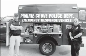  ?? LYNN KUTTER ENTERPRISE-LEADER ?? Prairie Grove Police Chief Chris Workman, left, and Sgt. Tim Standifer stand in front of the department’s new emergency response vehicle.