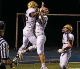  ?? MICHAEL REEVES — FOR DIGITAL FIRST MEDIA ?? Rustin running back Ty Pringle, left, celebrates a touchdown with teammate Sean Durant Friday night against Great Valley.