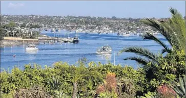  ?? Allen J. Schaben
Los Angeles Times ?? BOATERS navigate Newport Harbor in Newport Beach. In an effort to ease crowding during the busy summer boating season, the Harbor Commission recommende­d in 2015 that the city test a second anchorage.