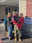  ?? COURTESY OF CHRISTINE REGAN ?? From left, Brianna Eble, Arthur Eble and their two sons, Liam, 3, and Declan, 4, reunite outside of Tewksbury’s Building Blocks March 10, 2023. Arthur
Eble returned home after spending nearly 11 months in Djibouti with the U.S. Navy.