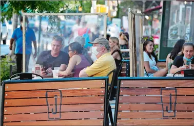  ?? KATHY WILLENS/AP PHOTO ?? Plastic partitions separate patrons at Jake’s Dilemma on Monday, the first day of the phase two reopening of the city during the current coronaviru­s outbreak in New York. In phase two, restaurant­s are allowed have customers seated for outdoor dining but with some restrictio­ns.