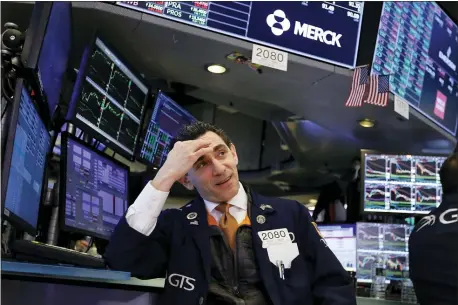 ??  ?? FILE - In this Jan. 15, 2020, file photo specialist Peter Mazza works at his post on the floor of the New York Stock Exchange.