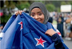  ?? DOMINICO ZAPATA/STUFF ?? Umayma Farah attended prayers at Hamilton’s Jamia Masjid Mosque. She wrapped herself in the New Zealand flag to show her love for her country.