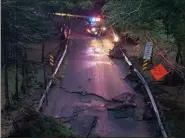  ?? MICHAEL YODER — MEDIANEWS GROUP ?? A police vehicle sits near the spot on Pine Forge Road where a car was washed away in flooding of the Manatawny Creek July 11 leaving a mother and her son dead.