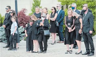  ?? NATHAN DENETTE THE CANADIAN PRESS ?? Family members react as they watch the arrival of the caskets of Karolina Ciasullo and her three young daughters, killed in a car crash, at their funeral service in Brampton, Ont., on Thursday.