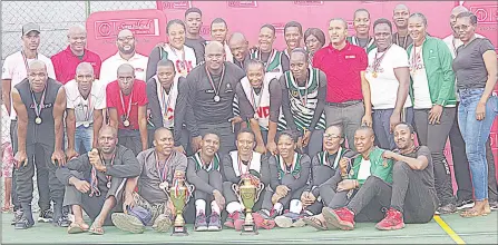  ?? (Pic: Nimrod Hlophe) ?? Swaziland Building Society Elite Netball League winners Correction­al teams joined by SBS Marketing Manager Veli Dlamini (3rd L back) posing with their trophies after the prize presentati­on yesterday at OlympAfric­a Centre.