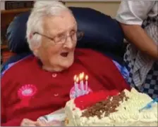  ??  ?? Loretta Dooley blowing out the candles on her birthday cake.