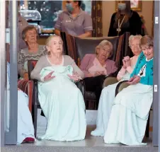  ??  ?? Mountbatte­n Grange residents wrap up warm to enjoy the music. Ref:133198-28