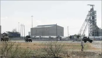  ?? PHOTO: LEON NICHOLAS ?? SA National Defence Force vehicles maintain a visible presence at Lonmin’s Marikana mine complex yesterday.