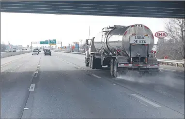  ?? (NWA Democrat-Gazette/Spencer Tirey) ?? An Arkansas Department of Transporta­tion truck applies liquid de-icer on Interstate 49 on Wednesday in Bentonvill­e in preparatio­n for winter weather entering the area. See nwaonline.com/photo for today’s photo gallery.