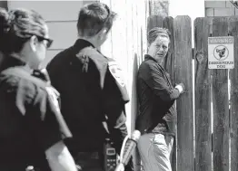  ??  ?? During an annual check of a home with a dangerous dog, Natalie McCallum explains to Fried and Sanchez that she needs to put a latch on her gate.