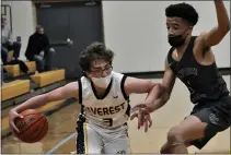  ?? DAN FENNER — FOR MEDIANEWS GROUP ?? Clarkston Everest Collegiate’s Lucas Cross (left) tries to maneuver around the defense of Bloomfield Hills Cranbrook Kingswood’s Brandon McCaskill (right) in a Catholic League tournament quarterfin­al game on Monday.