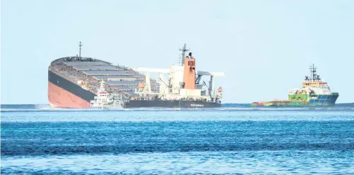  ?? | Reuters ?? THE BULK carrier ship MV Wakashio, belonging to a Japanese company but Panamanian-flagged, that ran aground on a reef at Riviere des Creoles, Mauritius. Prime Minister Pravind Jugnauth said the carrier was still holding 2 000 tons of oil and was expected to break up.